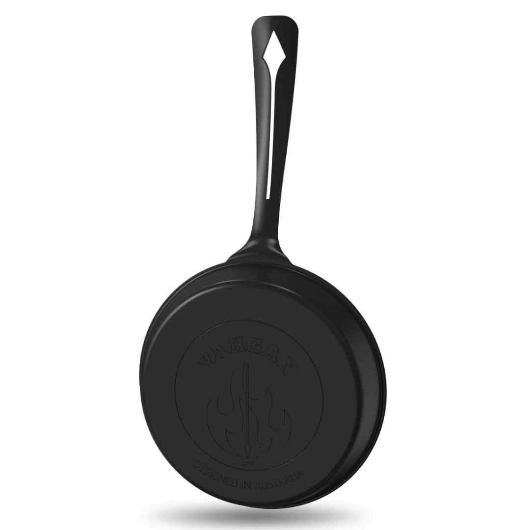 Back side view of Yahgan Black Series 26cm nitrided carbon steel pan with stamped Yahgan logo
