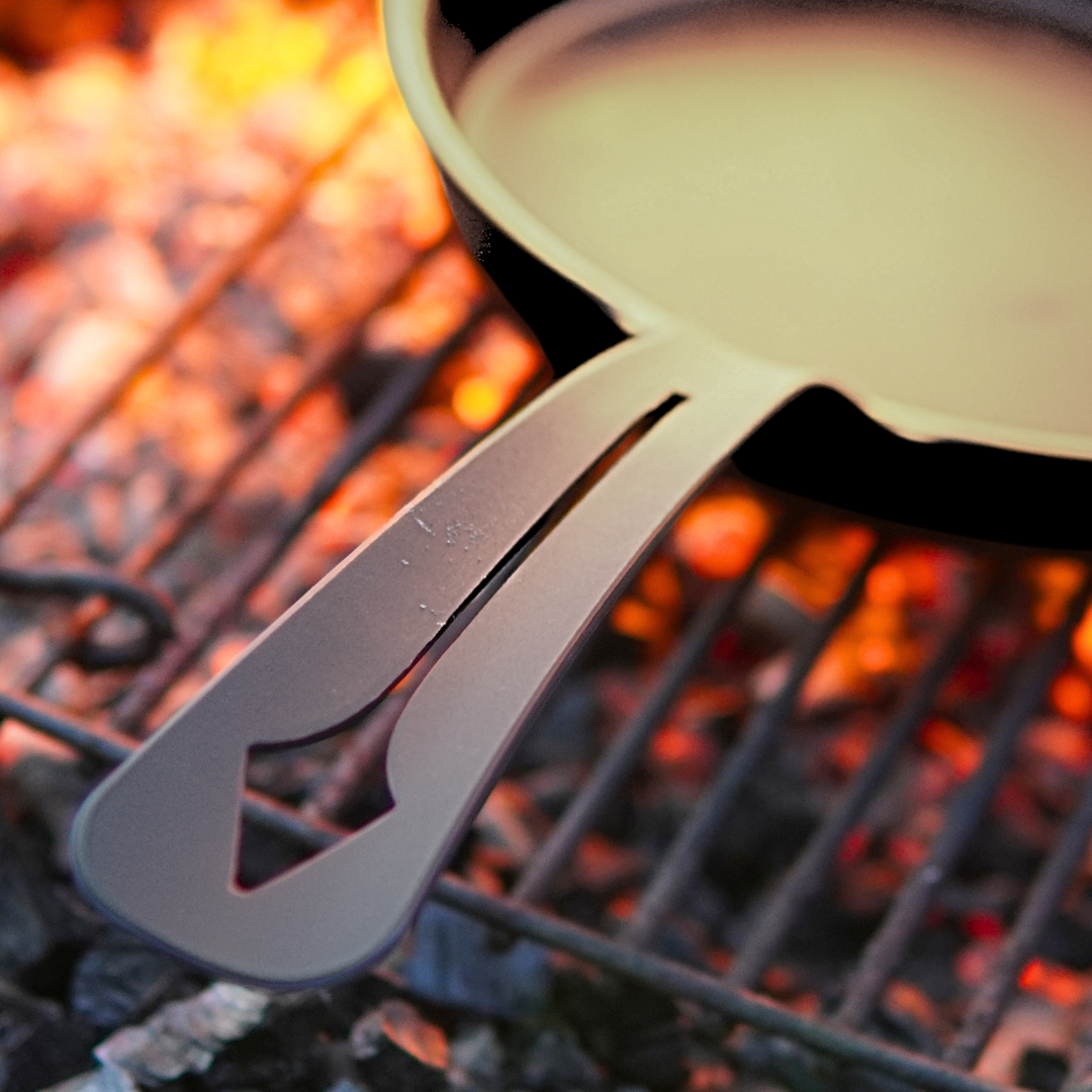 Yahgan Black Series carbon steel pan over campfire — one-piece forged, no weak points, built for open flame