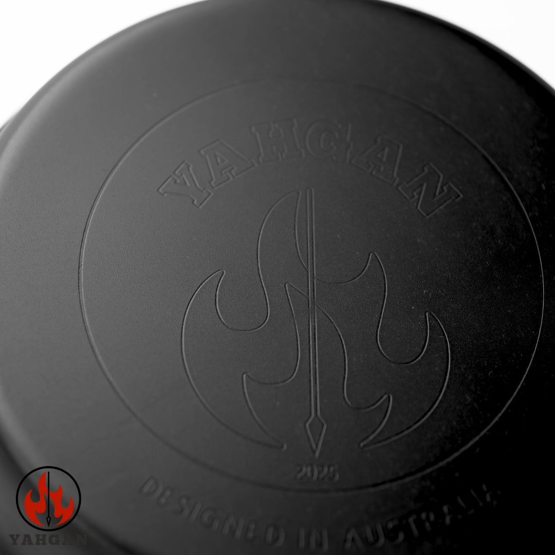 Close-up of Yahgan Black Series nitrided carbon steel surface logo stamp — rust-resistant, naturally non-stick with seasoning