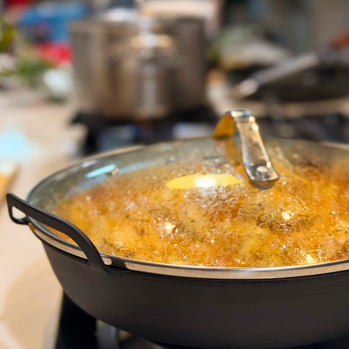 Yahgan 30cm tempered glass lid on a carbon steel pan, braising a stew on the stovetop