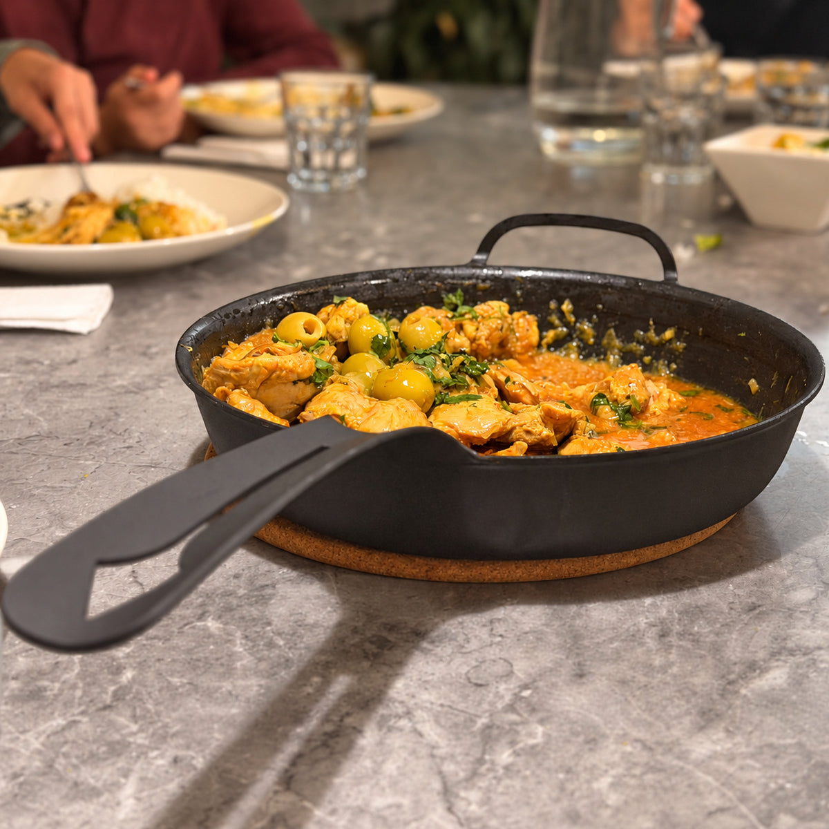 Yahgan Black Series 30cm carbon steel pan serving a family dinner in a home kitchen