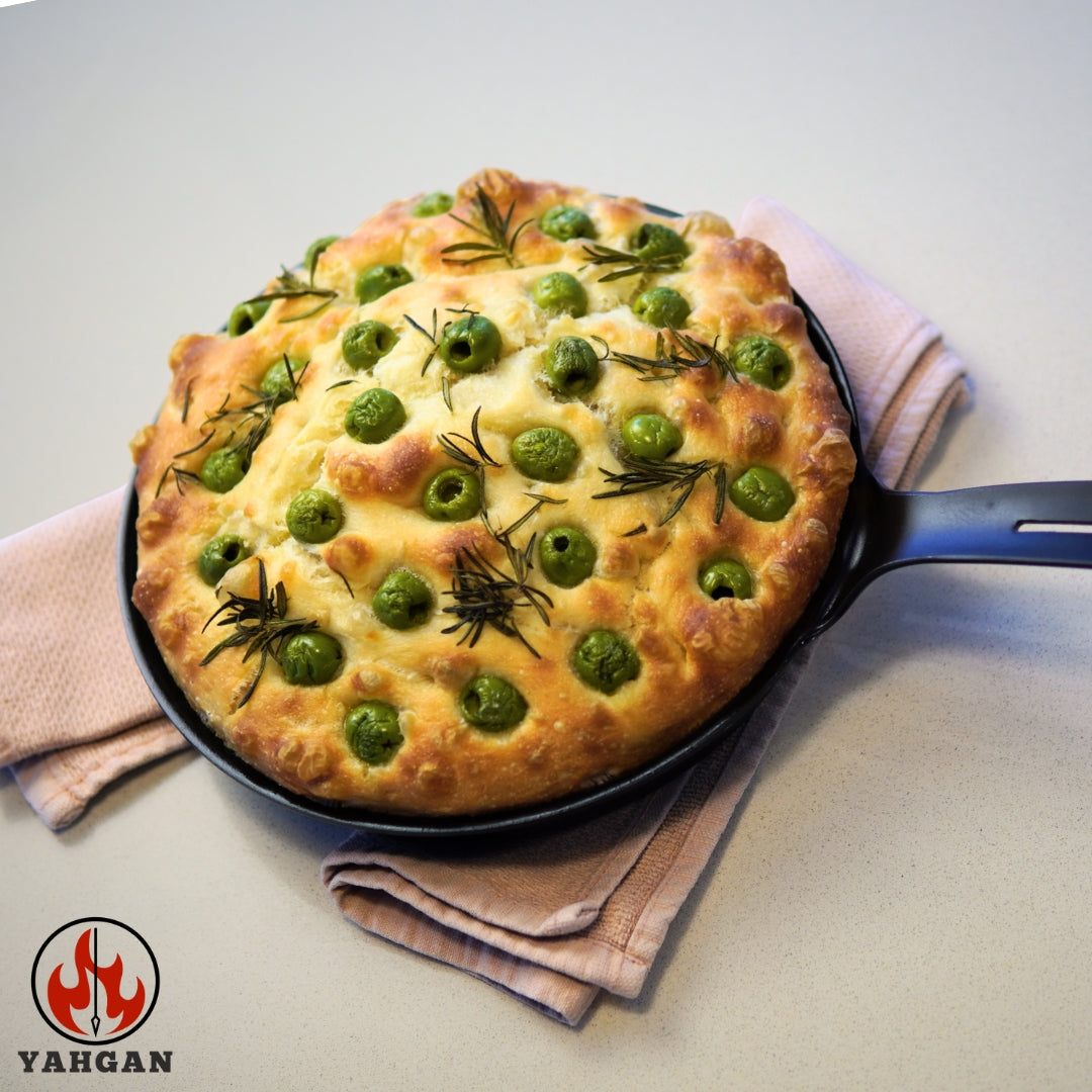 Focaccia cooking in Yahgan Classic Series 26cm carbon steel pan — naturally non-stick surface built through seasoning