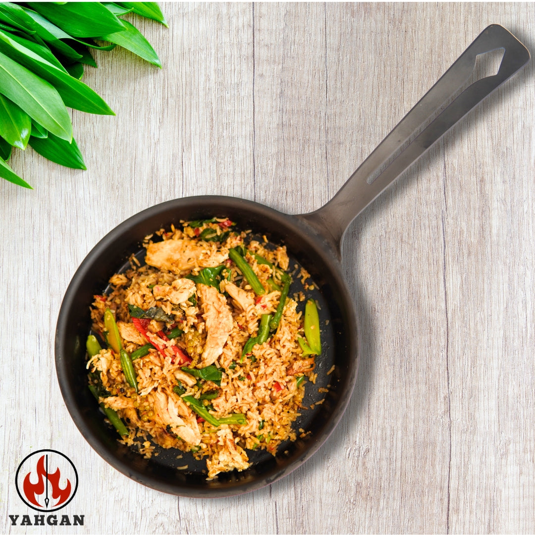 fried rice Eggs and vegetables cooking in Yahgan Classic Series carbon steel pan — seasoned surface delivers natural non-stick performance