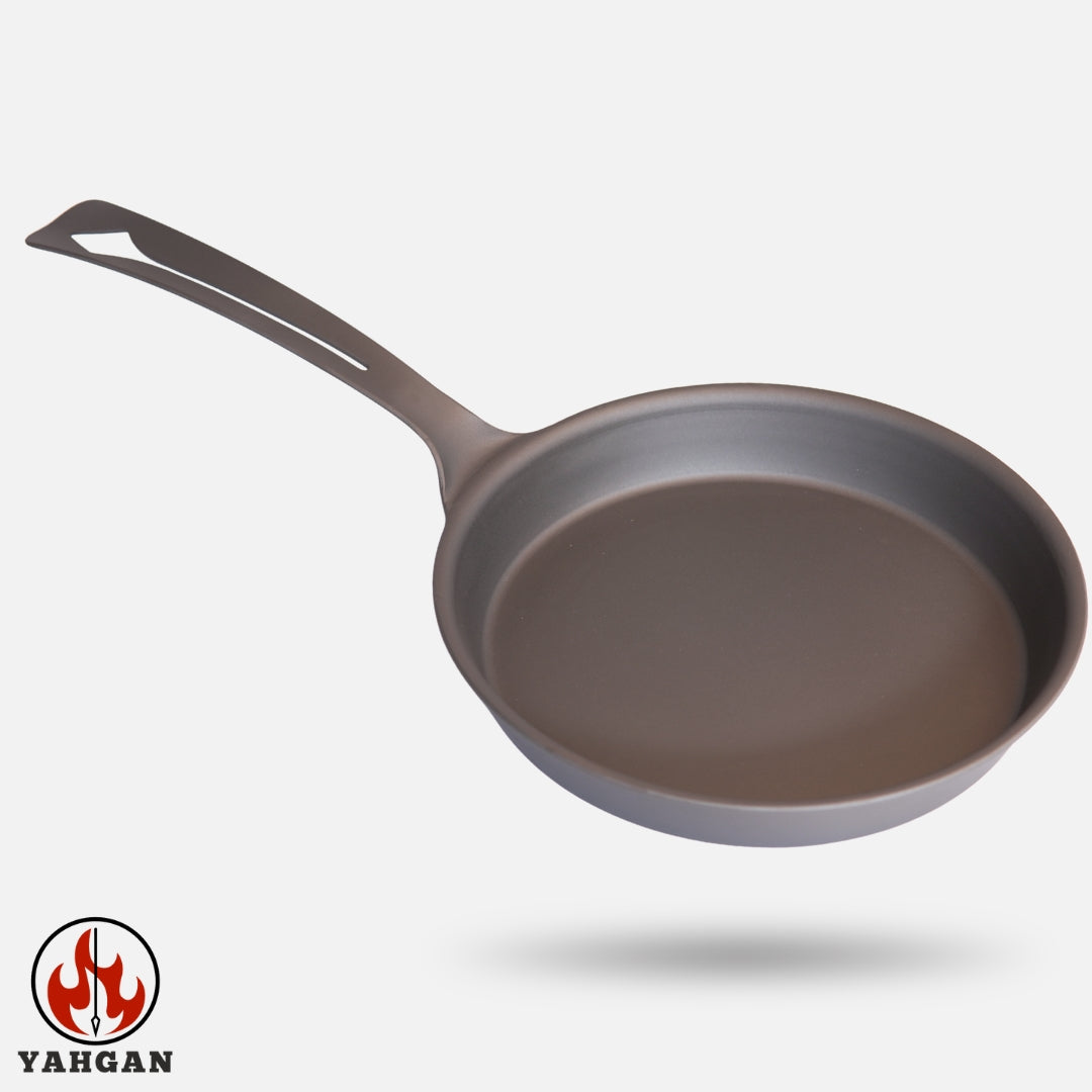 Top-down - side view of Yahgan Classic Series 26cm raw carbon steel pan — one-piece forged from ST12 carbon steel